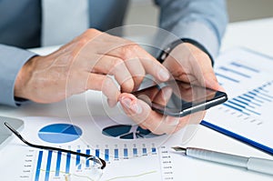 Close-up Of Businessman Using Cell Phone