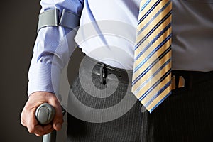 Close Up Of Businessman Using Crutch