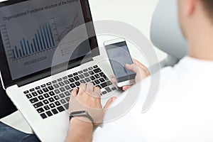 Close up. businessman using gadgets to check financial data