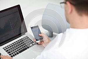 Close up. businessman using gadgets to check financial data