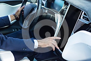 Close up of businessman using navigation system in his car