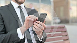 Close Up of Businessman Using Smartphone while Sitting Outdoor on Bench