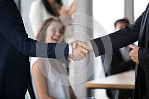 Close up of businessmen handshake closing successful business deal