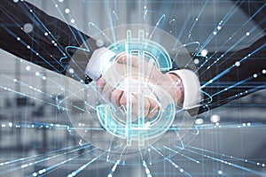 Close up of businessmen shaking hands with abstract glowing holographic dollar icon on blurry office interior background. Trade,