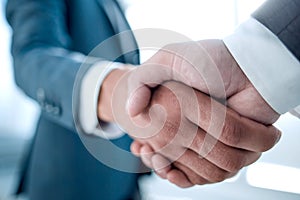 Close up of businessmen shaking hands business success ideas concept