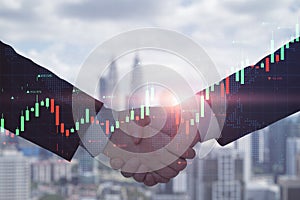 Close up of businessmen shaking hands on creative blurry city background with glowing forex chart and map. Teamwork, trade and