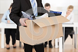 Businessperson Carrying Cardboard Box