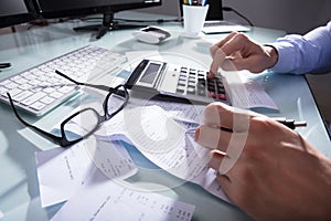 Close-up Of A Businessperson`s Calculating Receipt