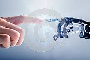 Businessperson`s Finger Touching Robotic Finger photo