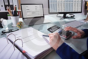 Businessperson Calculating Invoice photo