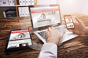 Businessperson Reading Online News On Laptop photo