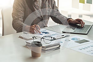 Close up of businesswoman or accountant hand holding pen working on calculator to calculate business data, accountancy