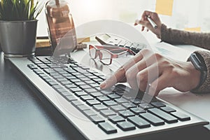 Close up of businesswoman or accountant hand holding pencil working on calculator to calculate financial data report, accountancy