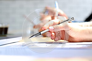 Close-up Of Businesswoman Analyzing Graph with collegues