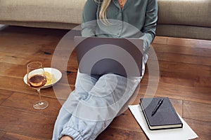 Close Up Of Businesswoman At End Of Day With Wine In Loungewear And Suit On Laptop Working At Home