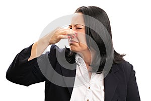 Close-up of businesswoman holding nose as bad smell concept photo