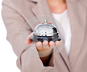 Close up of a businesswoman holding service bell