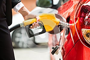 Close-up Of Businesswoman`s Hand Refueling Car`s Tank