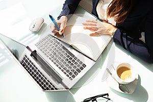 Close-up Of A Businesswoman`s Hand Writing Note In Diary