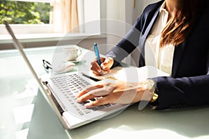 Close-up Of A Businesswoman`s Hand Writing Note In Diary