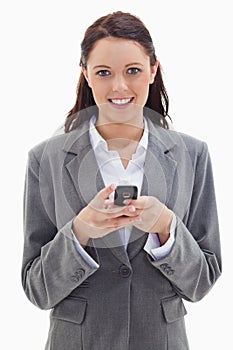 Close-up of a businesswoman smiling and holding her mobile