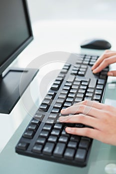 Close up of a businesswoman typing on a computer