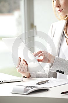 Close-up of businesswoman is typing on her tablet