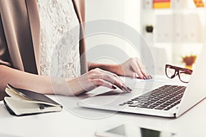 Close up of businesswoman typing at laptop