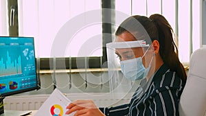 Close up of businesswoman wearing protection mask on desk office
