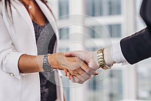 Close-up of businesswomen shaking hands greeting each other before meeting