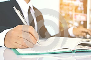 Close up of businesswomen writing on blue background