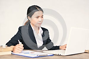 Close up of businesswomen writing on paper sheet in office