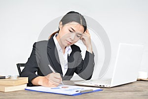 Close up of businesswomen writing on paper sheet in office