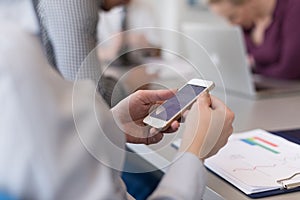 Close up of busineswoman hands using smart phone on meeting