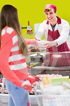 Close up of a butcher serving his customer