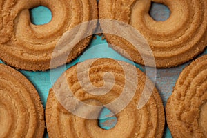 Close up of butter cookies/biscuits on wooden teal green rustic background, flat lay design with butter cookies photo