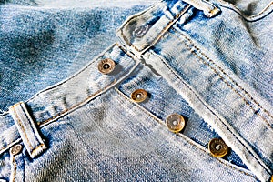 Close up of the buttons on blue jeans