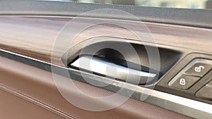 Close-up. Buttons for opening and closing car locks located on the door with wooden trim. Lock and unlock suv