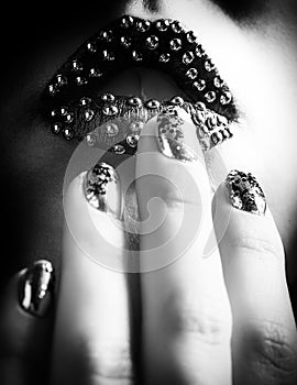 Close-up BW photo of metallic lips and Minx nails