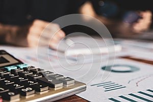 Close-up calculator,Asian young business man of student holding a pen writing letter on paper at home