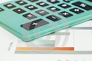 Close-up on calculator and coloreful chart