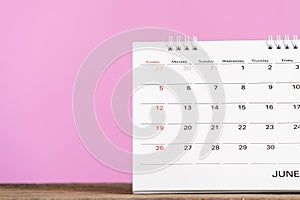 close up of calendar on the table with pink background, planning for business meeting or travel planning concept