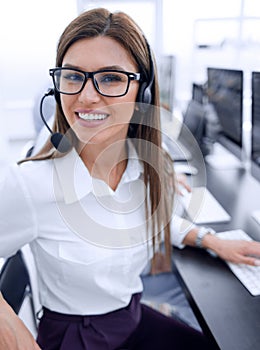 Close up. call center employee sitting at his Desk