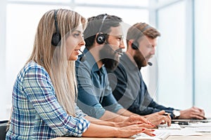 Call center operators use computers to work with clients.