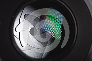 Close-up of a camera mirror lens front lens with aperture and highlights from a light source