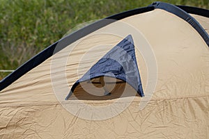 Close up of camping tent ventilation window detail with rain drops. Concept of waterproof cloth