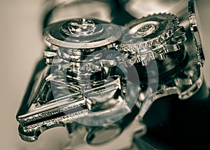 Close-up of can opener wheels and mechanism viewed from top side angle.