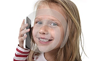 Close up candid portrait of beautiful female child with blond hair and blue eyes using mobile phone talking happy