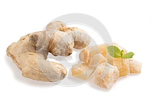 Close up of candied crystallized ginger candy pieces and ginger isolated on white background.