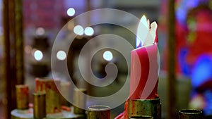 Close up candle burning in Chinese deity offering